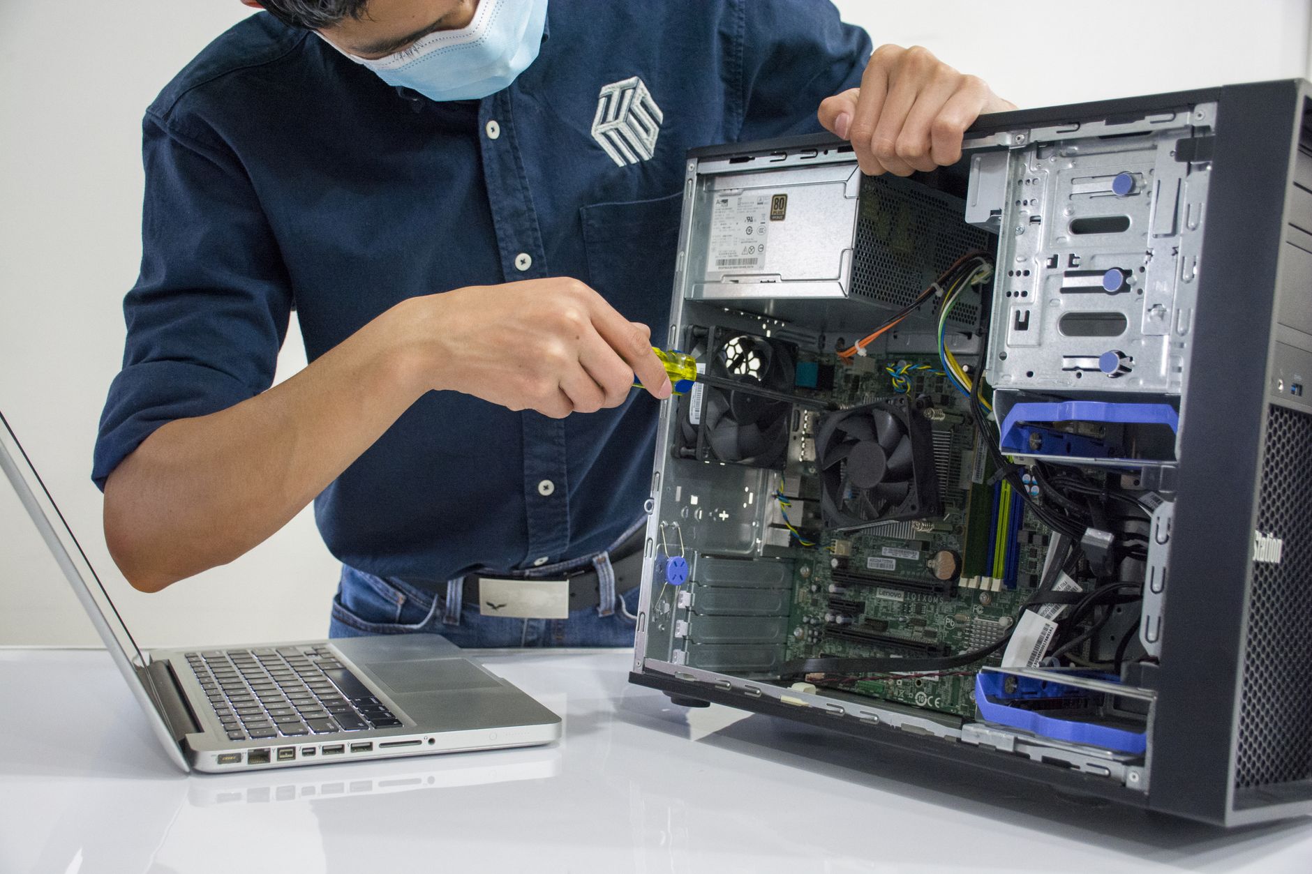Computer repair technician working on a device